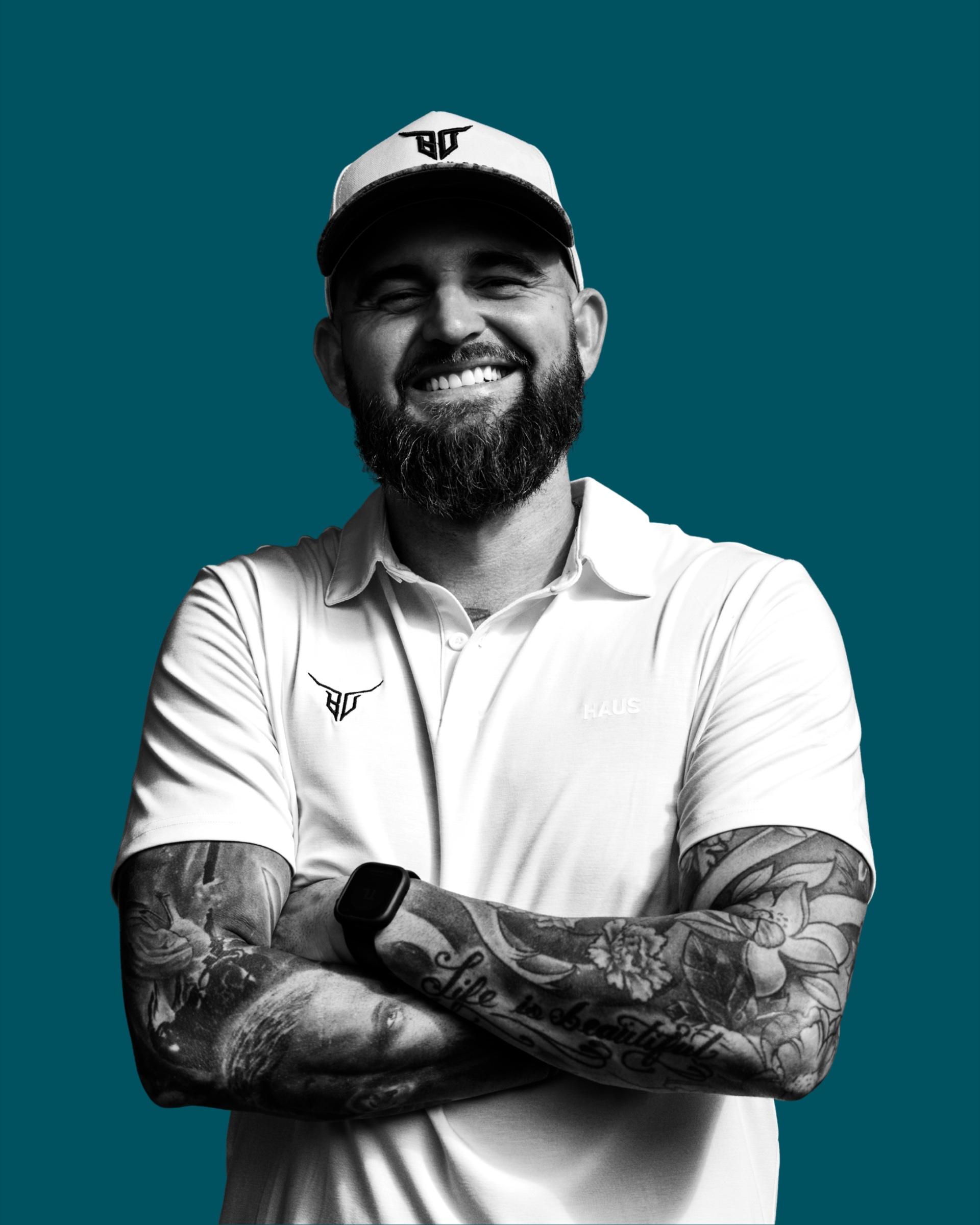 Logan Deel, founder of Built by Deel Construction, in a Built by Deel cap and polo