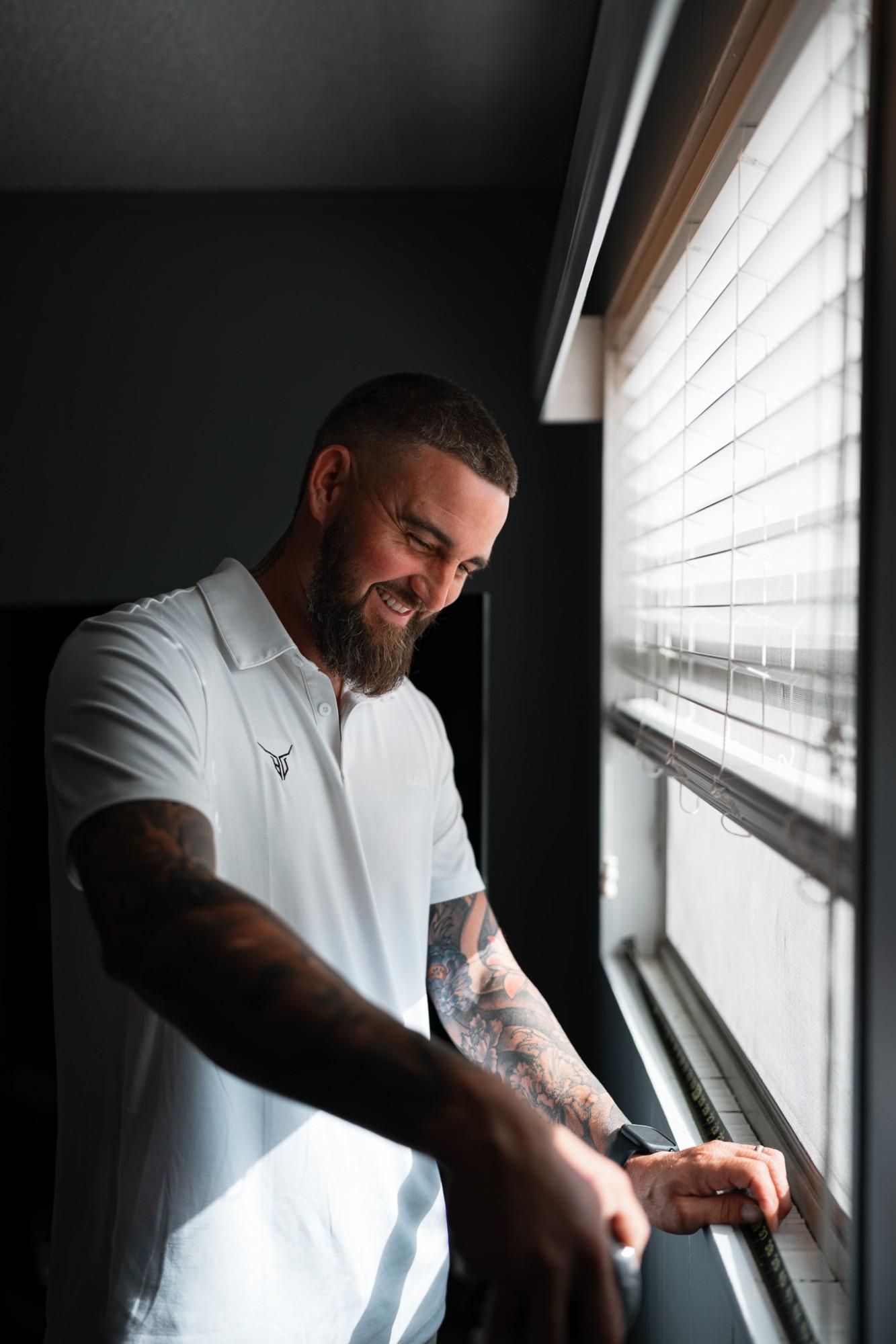 Logan Deel measuring a window opening